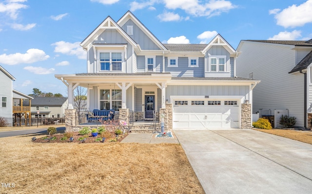 craftsman-style home with covered porch, board and batten siding, concrete driveway, and an attached garage