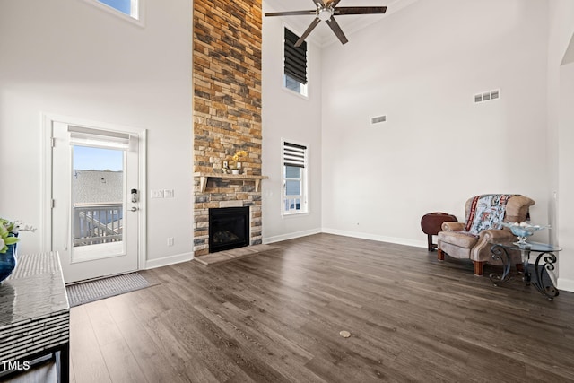 sitting room featuring baseboards, a fireplace, visible vents, and wood finished floors