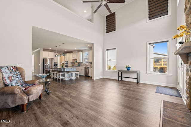 interior space featuring a healthy amount of sunlight, ornamental molding, and dark wood finished floors