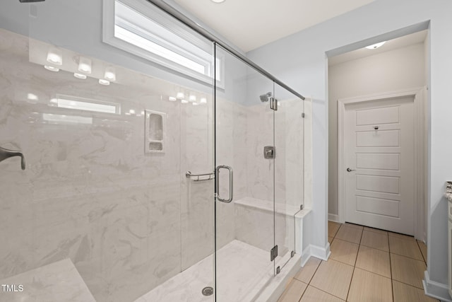 full bath with tile patterned flooring and a shower stall