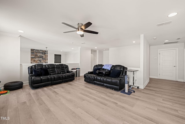 living area featuring recessed lighting, visible vents, crown molding, and wood finished floors