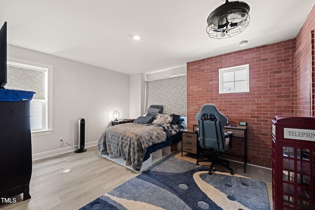 bedroom featuring baseboards and wood finished floors