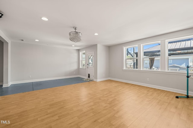 empty room featuring visible vents, baseboards, wood finished floors, and recessed lighting