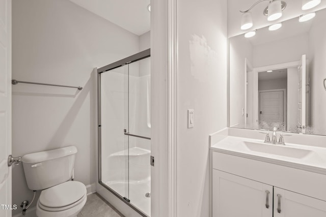 bathroom featuring tile patterned flooring, a shower stall, toilet, and vanity