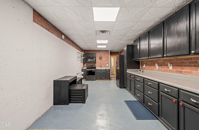 kitchen featuring black appliances, an ornate ceiling, visible vents, and light countertops