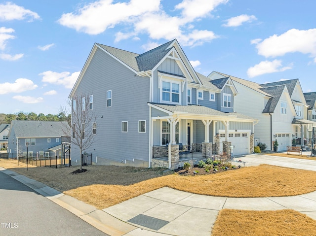 view of front of home with a porch, board and batten siding, fence, and a residential view