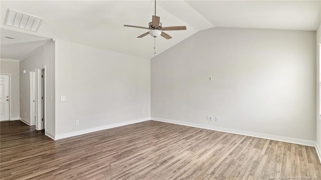 unfurnished room featuring wood finished floors, a ceiling fan, visible vents, vaulted ceiling, and baseboards