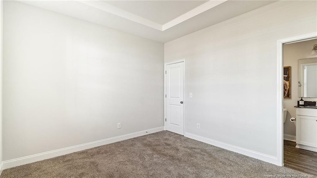 unfurnished bedroom with carpet and baseboards