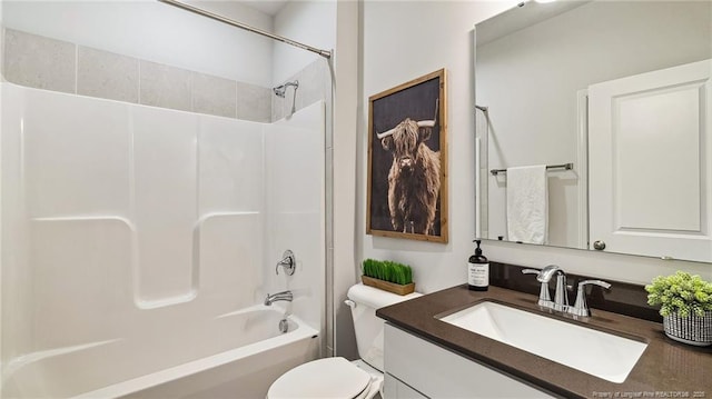 bathroom featuring washtub / shower combination, vanity, and toilet