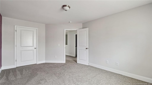 unfurnished bedroom with carpet and baseboards