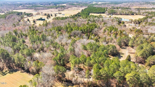 drone / aerial view with a water view and a view of trees