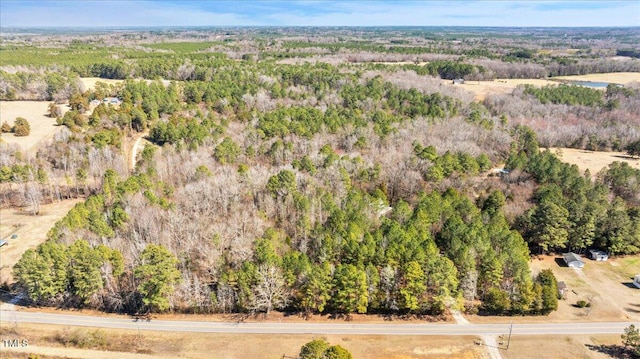 birds eye view of property featuring a view of trees