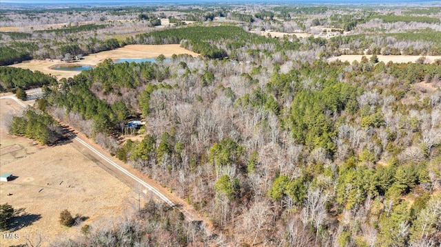 birds eye view of property with a water view and a forest view