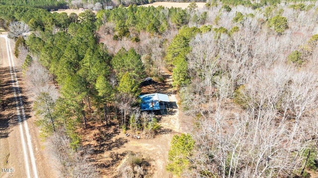 birds eye view of property featuring a view of trees