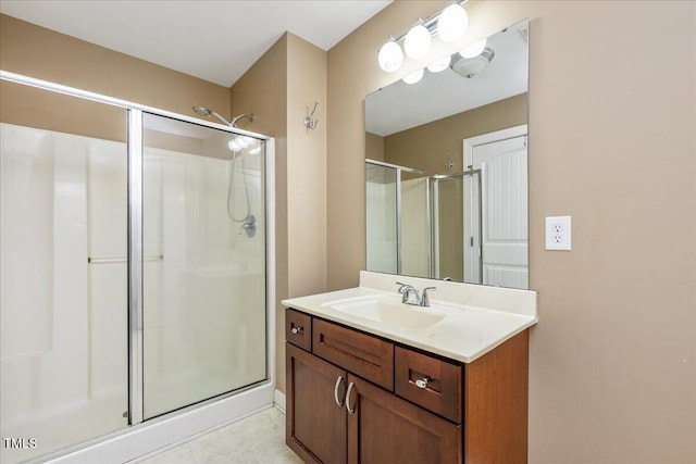 bathroom featuring a shower stall and vanity