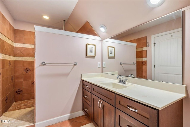 full bathroom featuring lofted ceiling, walk in shower, vanity, and tile patterned floors