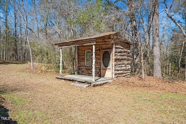 view of outbuilding with an outdoor structure and a wooded view