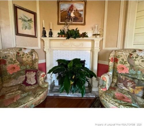 sitting room with a tile fireplace