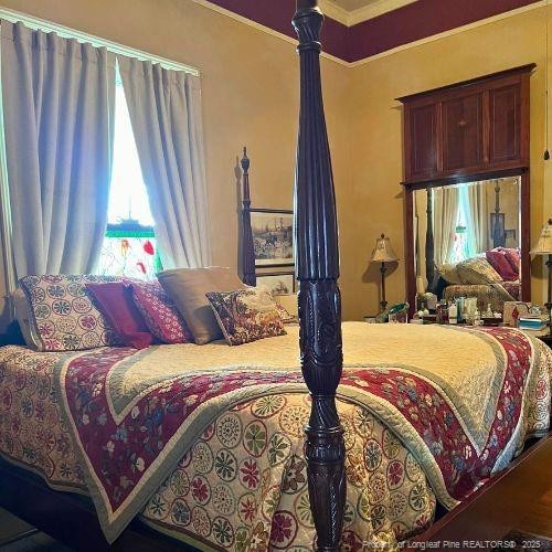 bedroom with ornamental molding