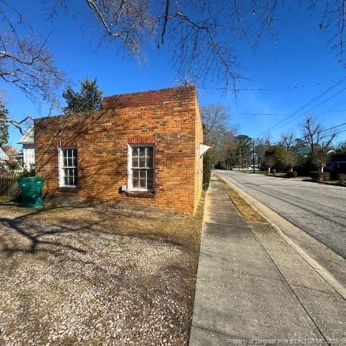 view of side of property featuring brick siding