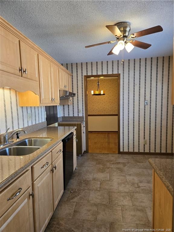 kitchen with a sink, wallpapered walls, a textured ceiling, and dishwasher