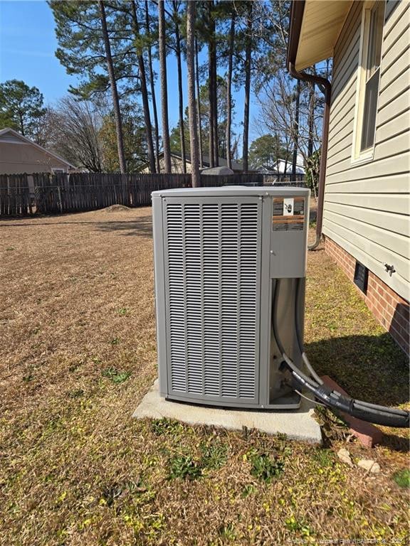 details with crawl space, fence, and central AC unit