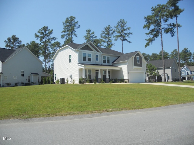 view of front of home featuring a garage, driveway, central AC unit, a residential view, and a front yard