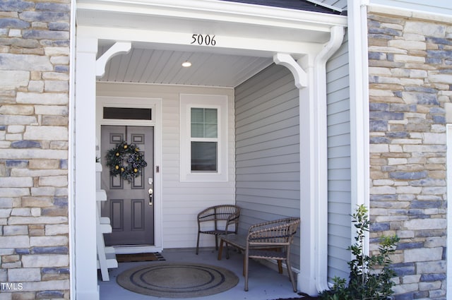 doorway to property featuring stone siding