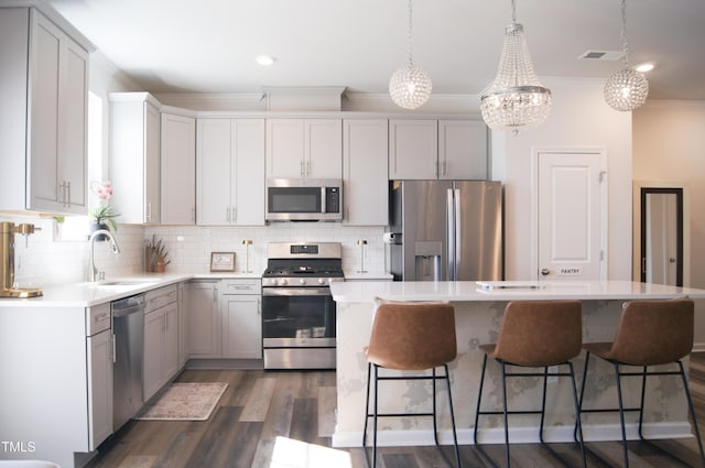 kitchen featuring visible vents, a sink, decorative backsplash, appliances with stainless steel finishes, and crown molding