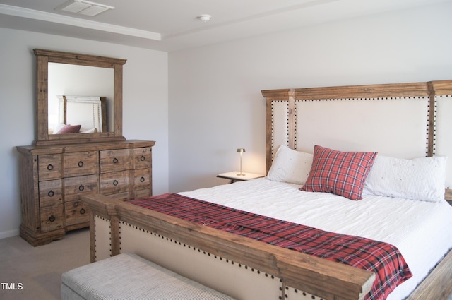 carpeted bedroom featuring visible vents