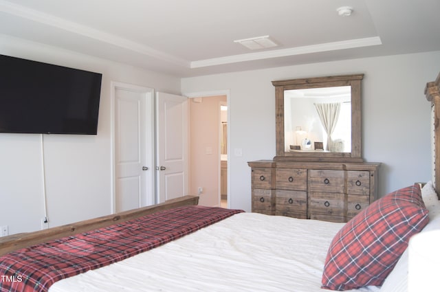 bedroom with visible vents and a raised ceiling