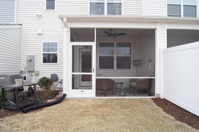 back of house featuring a patio area, a lawn, central AC, and a sunroom