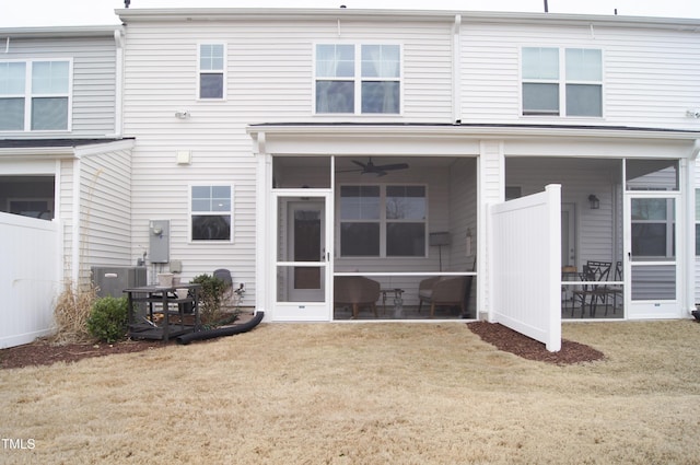 back of house with central air condition unit, a yard, and a sunroom