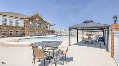 community pool featuring a gazebo and a patio area