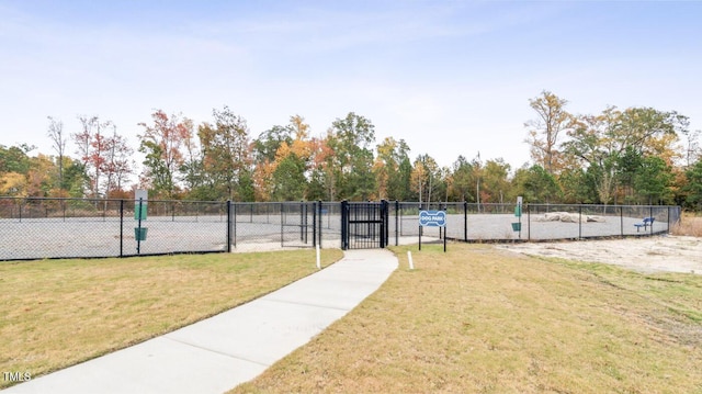 view of property's community with a yard and fence