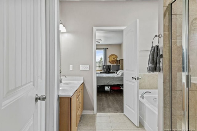 bathroom featuring ensuite bathroom, a shower stall, a bath, tile patterned floors, and double vanity