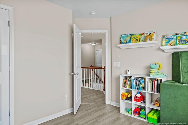 game room featuring baseboards and wood finished floors