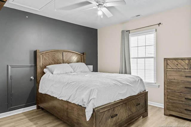 bedroom with multiple windows, visible vents, and wood finished floors