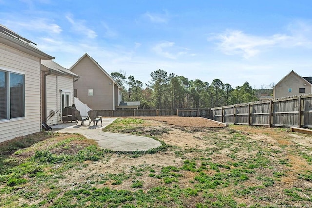 view of yard featuring a patio area and a fenced backyard