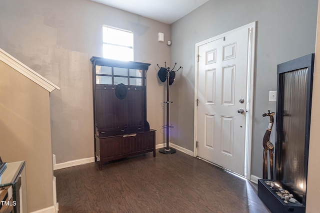 entryway featuring dark wood-style flooring and baseboards