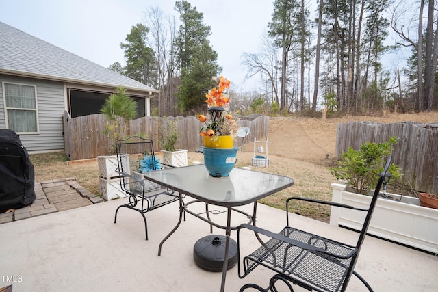 view of patio with fence and outdoor dining area