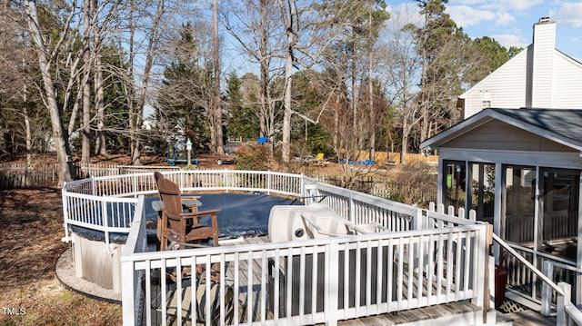 wooden deck with a sunroom