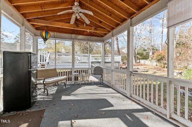 sunroom / solarium featuring lofted ceiling and ceiling fan