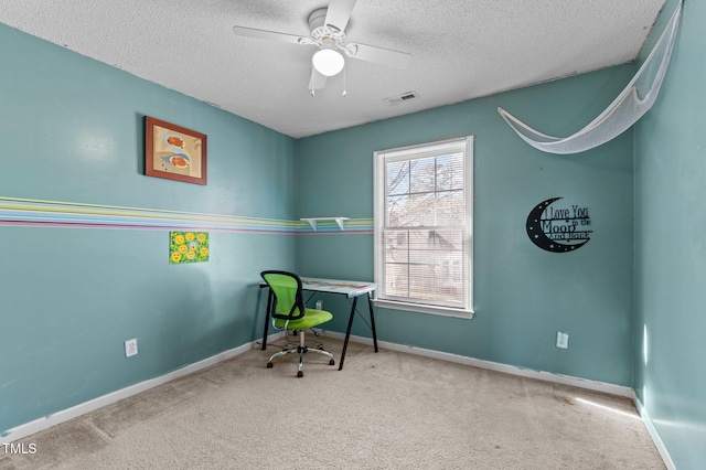 office area featuring a textured ceiling, carpet, visible vents, and baseboards