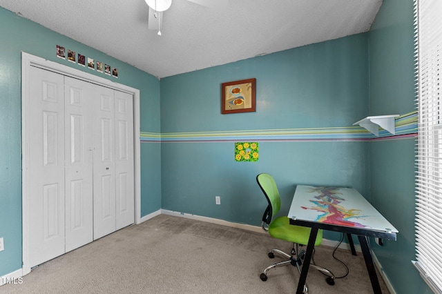 carpeted office space featuring plenty of natural light and baseboards