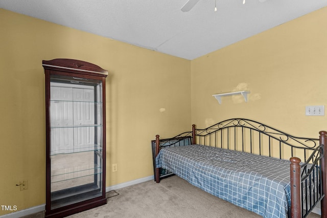 bedroom with carpet floors, ceiling fan, and baseboards