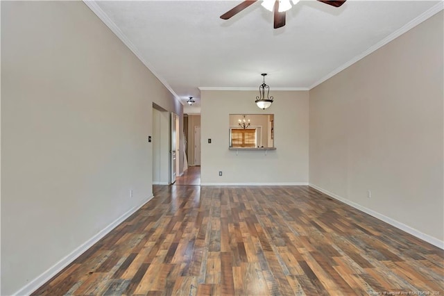 empty room featuring crown molding, ceiling fan with notable chandelier, wood finished floors, and baseboards