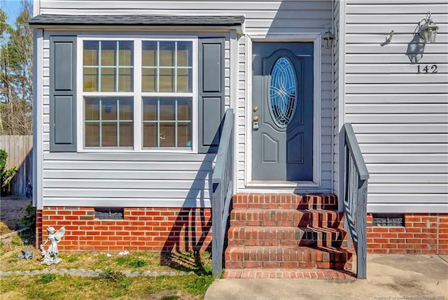 doorway to property with crawl space and fence