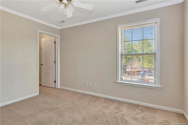 empty room featuring baseboards, a ceiling fan, light colored carpet, and crown molding