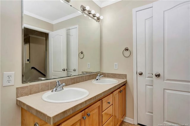 bathroom with double vanity, ornamental molding, and a sink